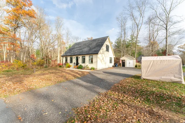 a view of a house with a yard and garage
