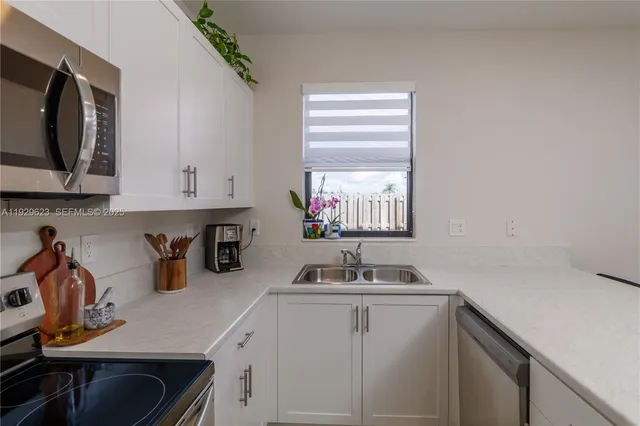 a kitchen with a sink cabinets and window