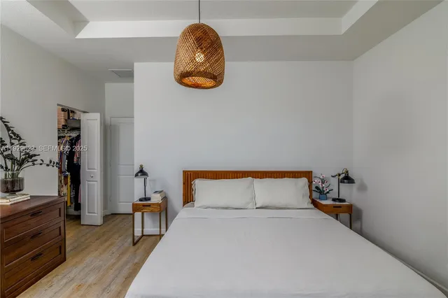 a bedroom with a bed and a table in it