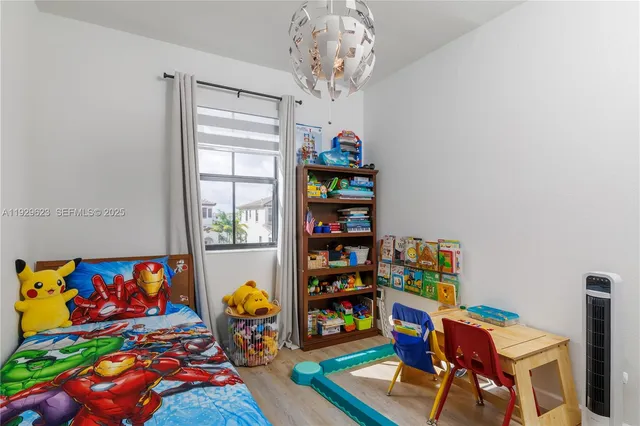 a bedroom with furniture and a book shelf