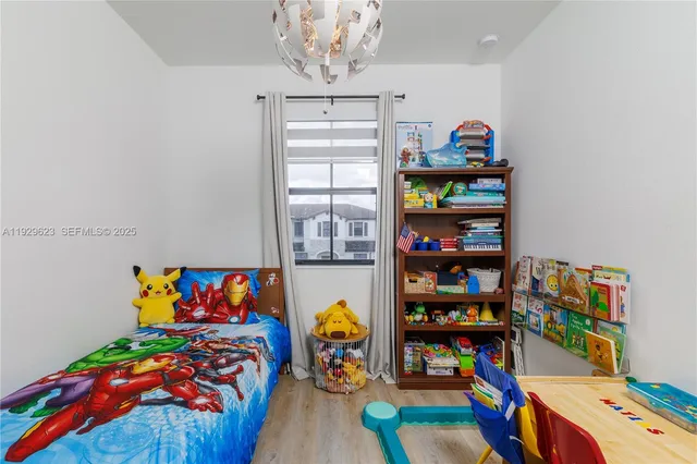 a bedroom with a bed and a book shelf