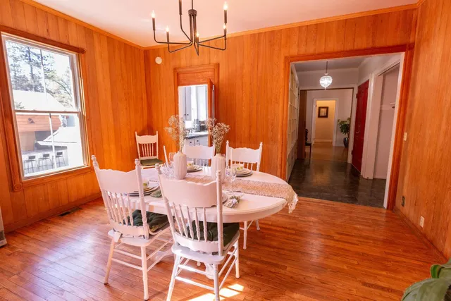 a kitchen with stainless steel appliances granite countertop a sink a stove and a wooden floor