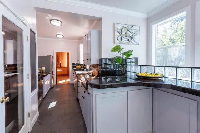 a living room with furniture and floor to ceiling windows