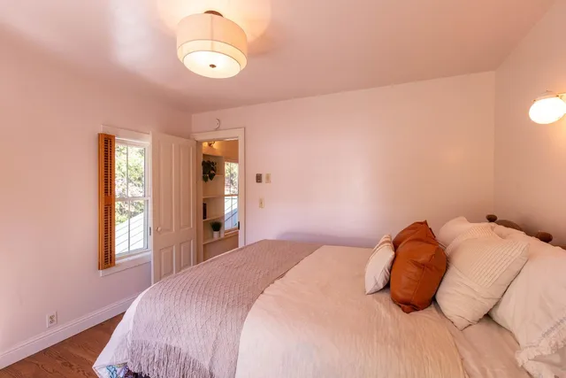 a bedroom with a bed and a night stand