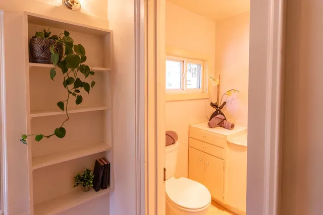 a bedroom with a bed and a potted plant