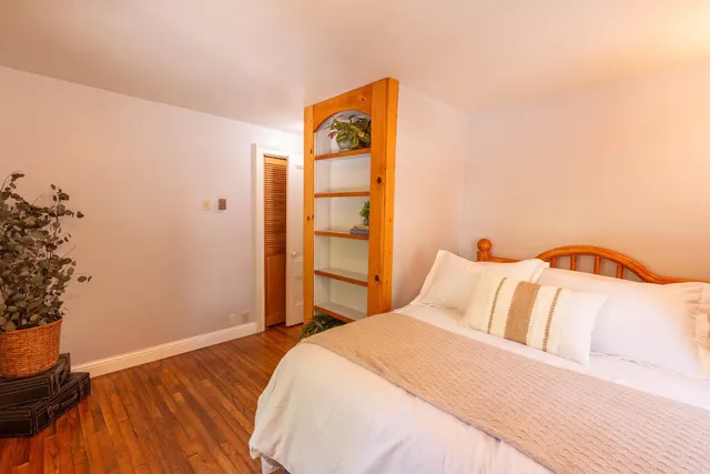 a view of yard with green space and trees in the background