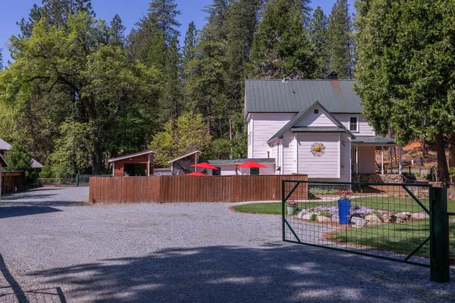 a backyard of a house with table and chairs