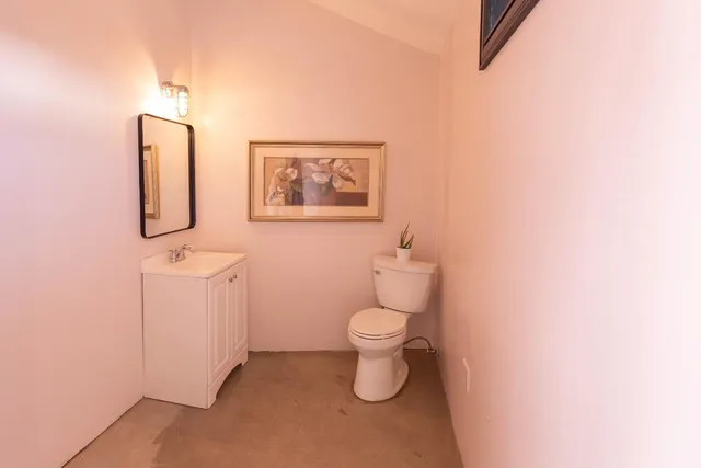 a view of a backyard with wooden fence and large trees