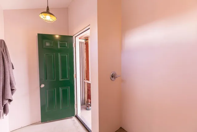a view of a house with a yard and a tree