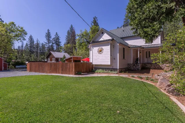 a view of a chairs and table in the backyard
