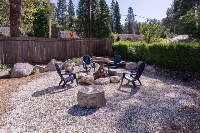 a view of a house with a yard and sitting area