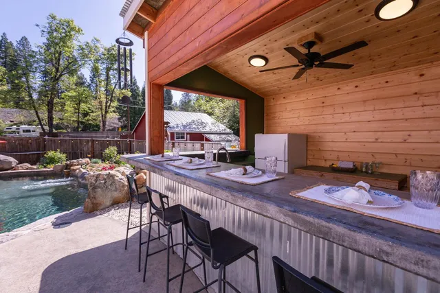 a view of a patio with a table chairs and a backyard