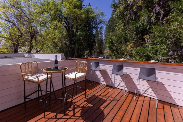 a view of balcony with wooden floor and outdoor seating