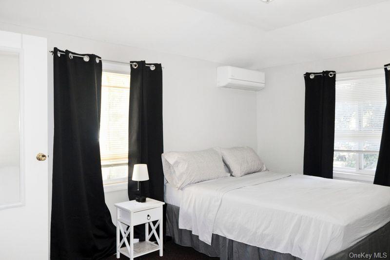 219-19 143rd Road Queens, NY 11413 - Photo 3 of 10 a bedroom with a bed and a table