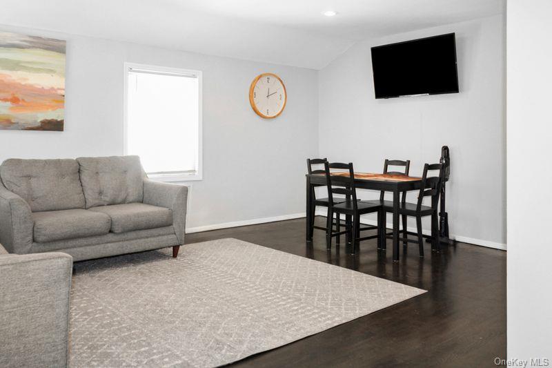 219-19 143rd Road Queens, NY 11413 - Photo 4 of 10 a living room with furniture and a flat screen tv