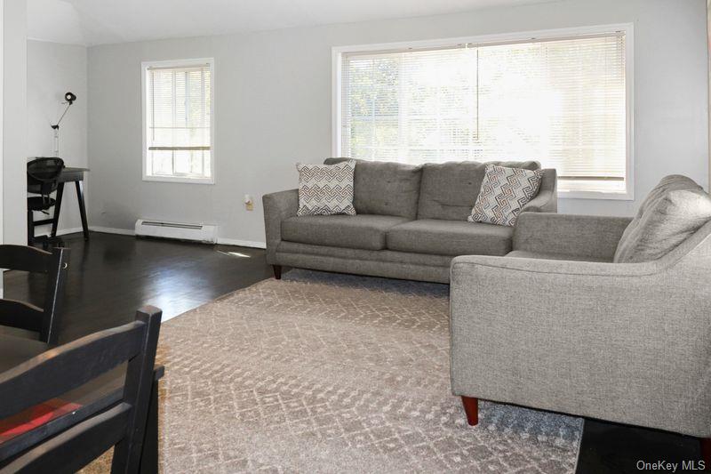 219-19 143rd Road Queens, NY 11413 - Photo 7 of 10 a living room with furniture and a window