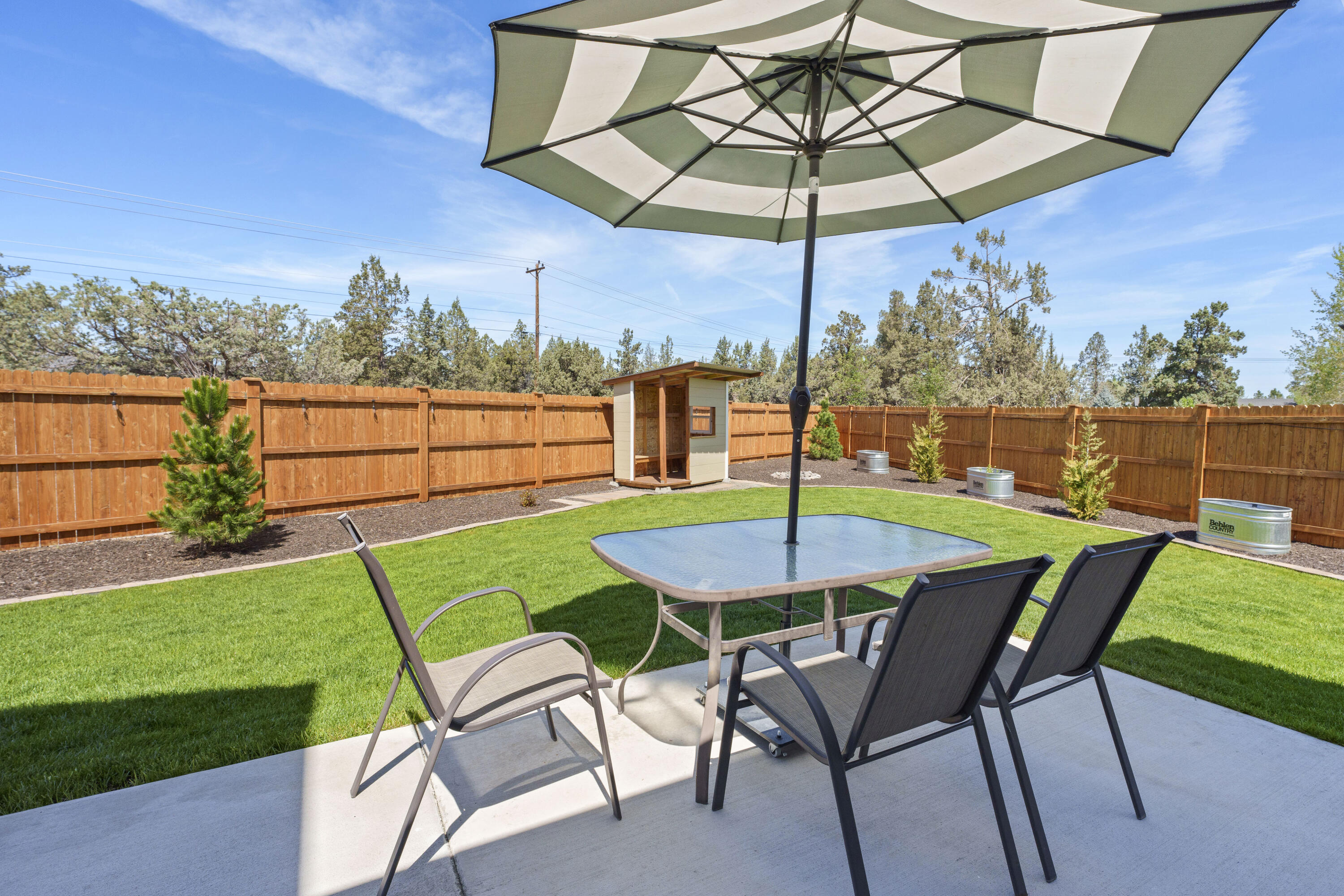 4999 Southwest Yew Place Redmond, OR 97756 - Photo 34 of 50 a view of a backyard with a patio and outdoor seating