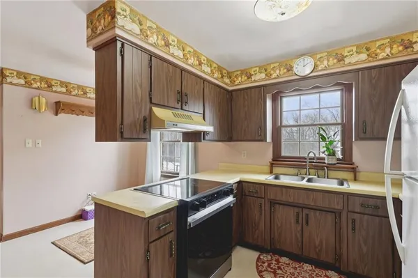 a kitchen with stainless steel appliances granite countertop a sink stove and cabinets