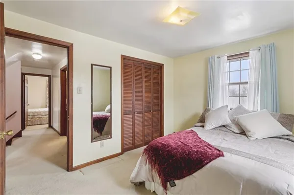 a bedroom with a bed and a mirror