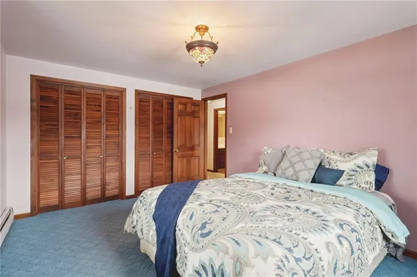 a bedroom with a bed and a dresser