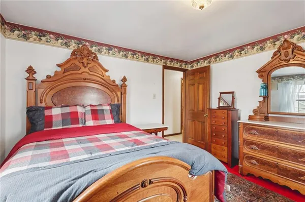 a bedroom with a bed and a dresser