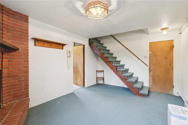 a view of entryway with stairs and wooden floor