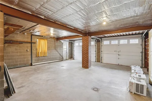 a view of an empty room with a fireplace and a window