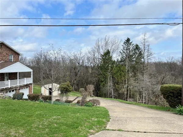 a living room with furniture a fireplace and a large window