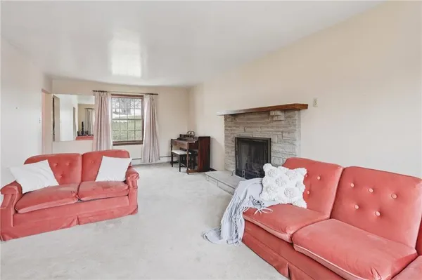 a living room with furniture fireplace and a window