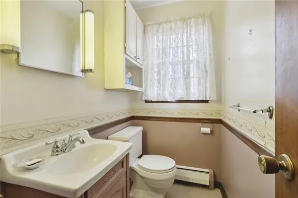 a bathroom with a sink a toilet and a mirror