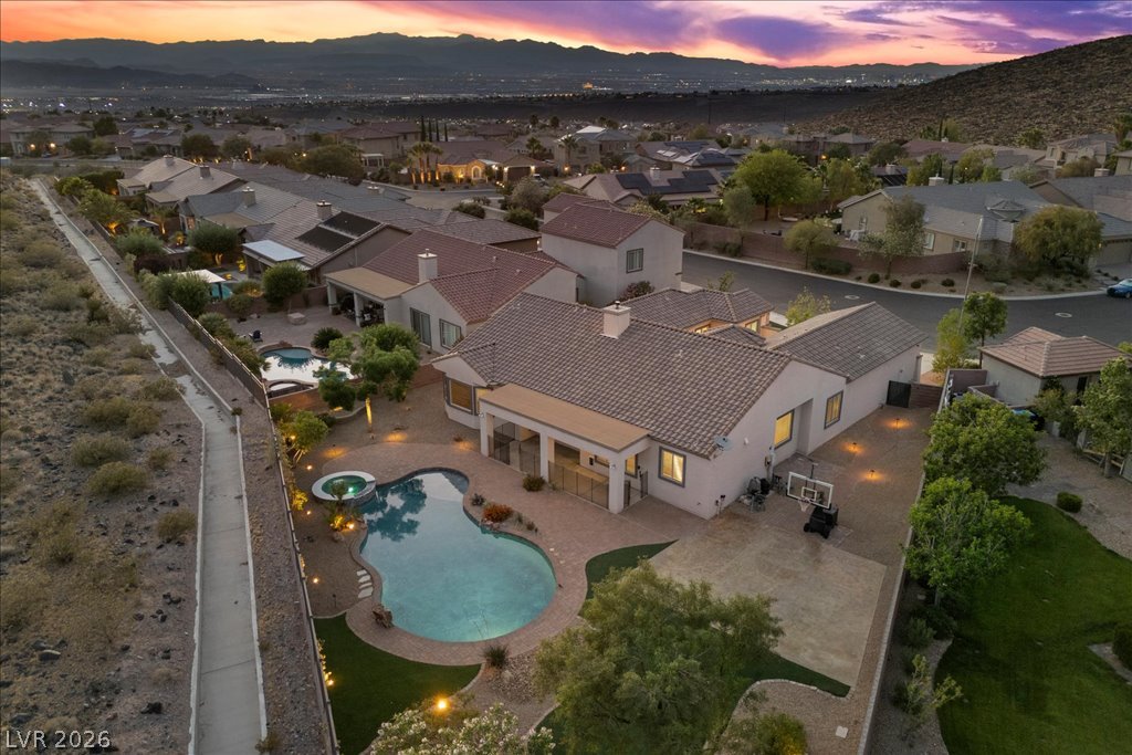 2125 De Rouge Avenue Henderson, NV 89044 - Photo 96 of 96 An aerial perspective reveals a serene backyard oasis, perfect for twilight relaxation and entertainment.