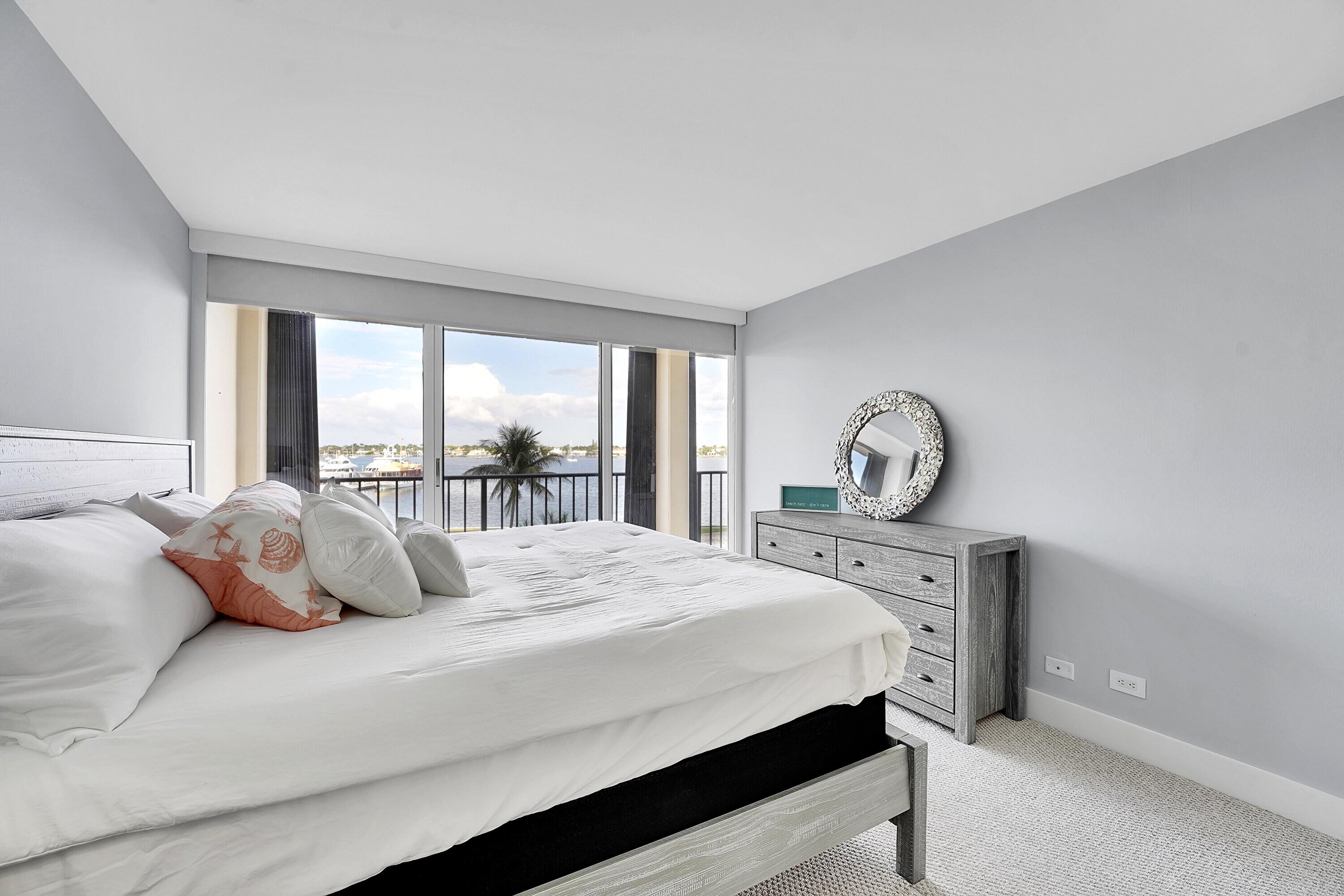 134 Lakeshore Drive, Unit 316 North Palm Beach, FL 33408 - Photo 16 of 30 a bedroom with a bed and a table