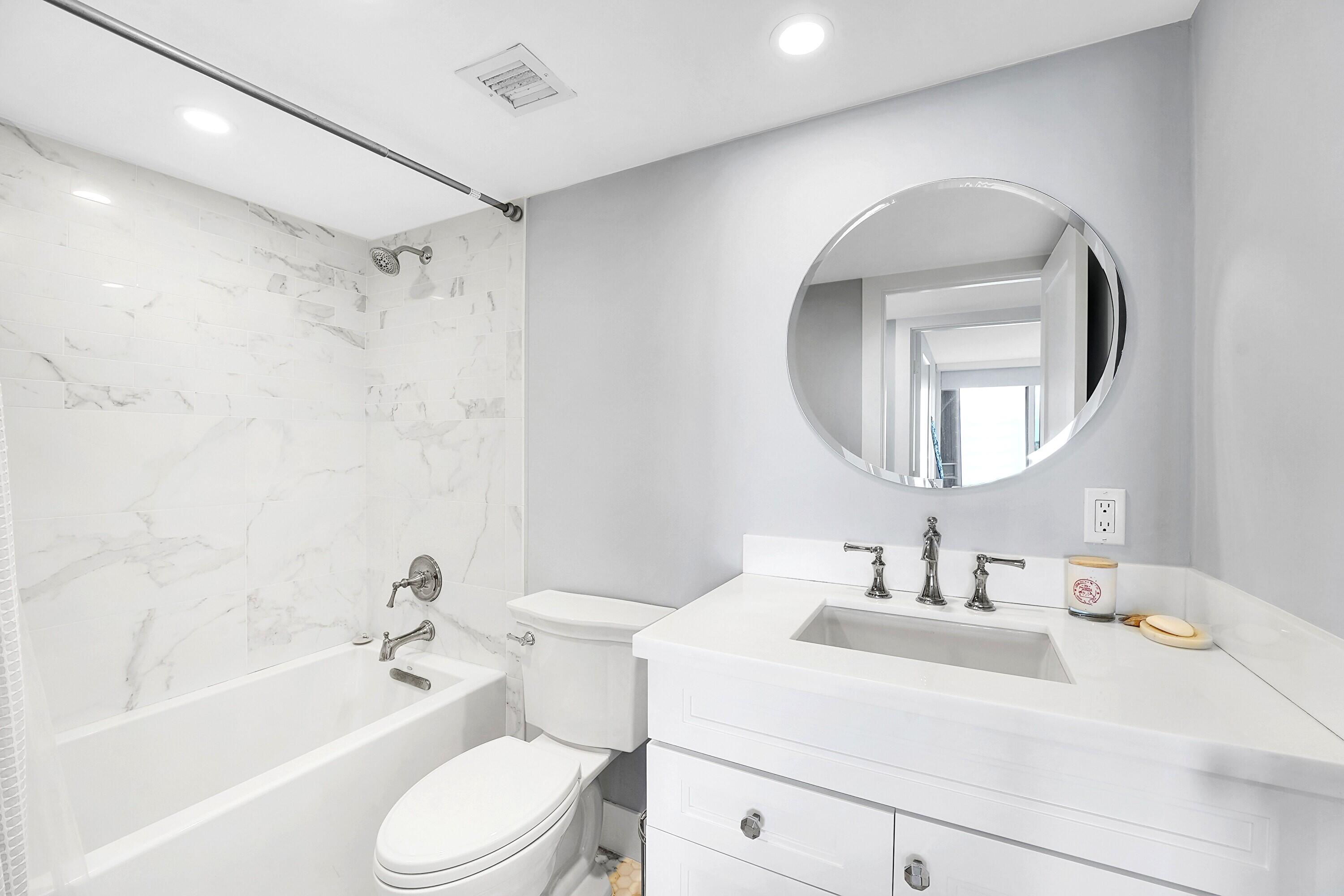 134 Lakeshore Drive, Unit 316 North Palm Beach, FL 33408 - Photo 18 of 30 a bathroom with a sink toilet and shower