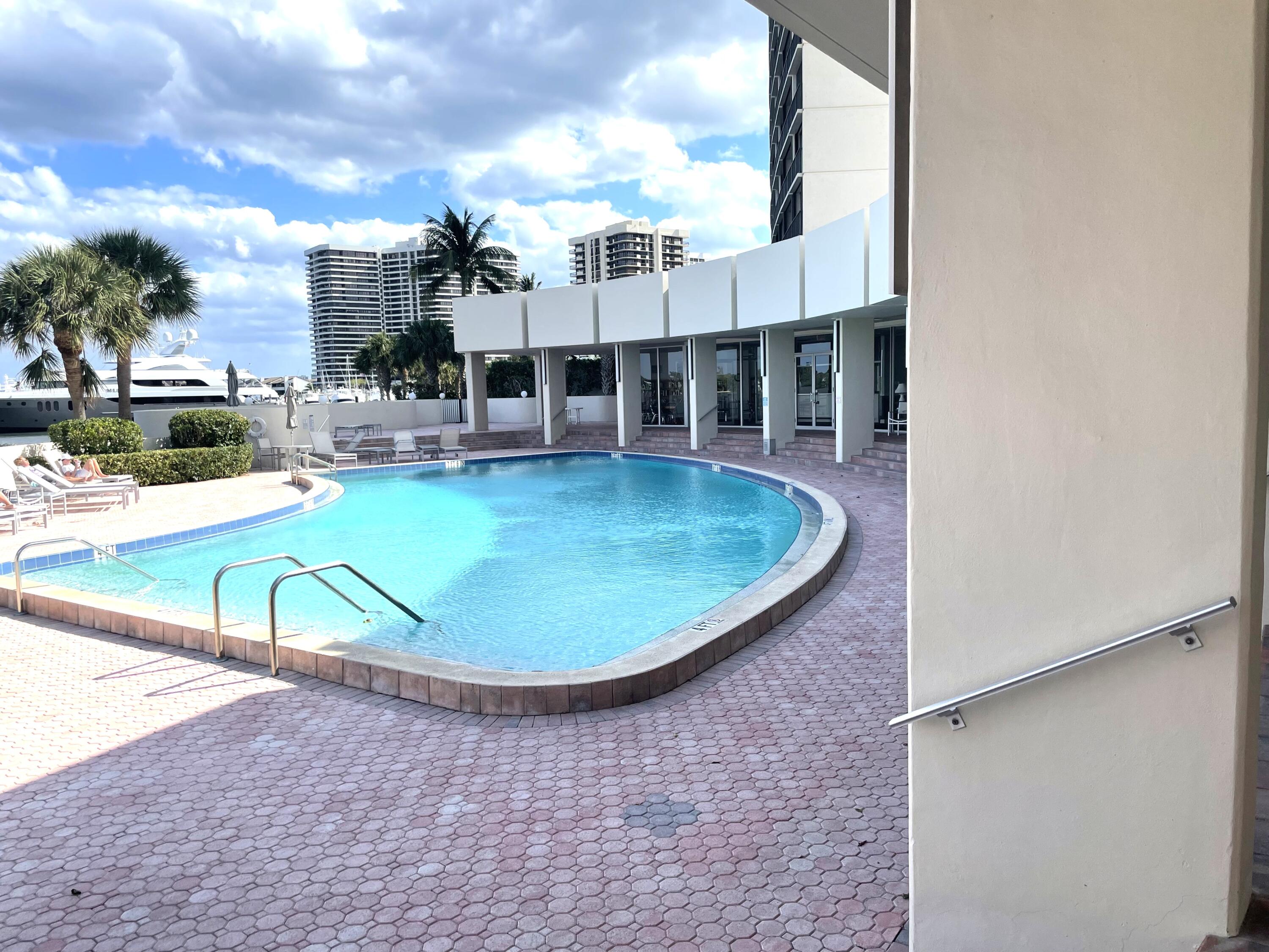 134 Lakeshore Drive, Unit 316 North Palm Beach, FL 33408 - Photo 22 of 30 a view of a swimming pool with outdoor seating