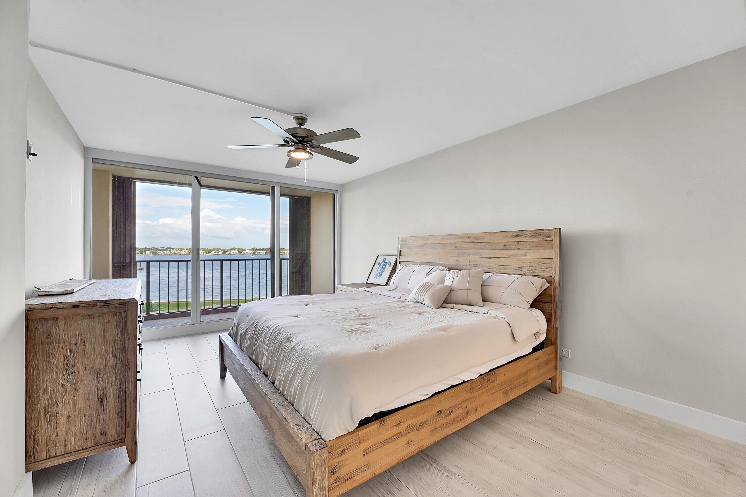134 Lakeshore Drive, Unit 316 North Palm Beach, FL 33408 - Photo 8 of 30 a large bedroom with a bed and large window