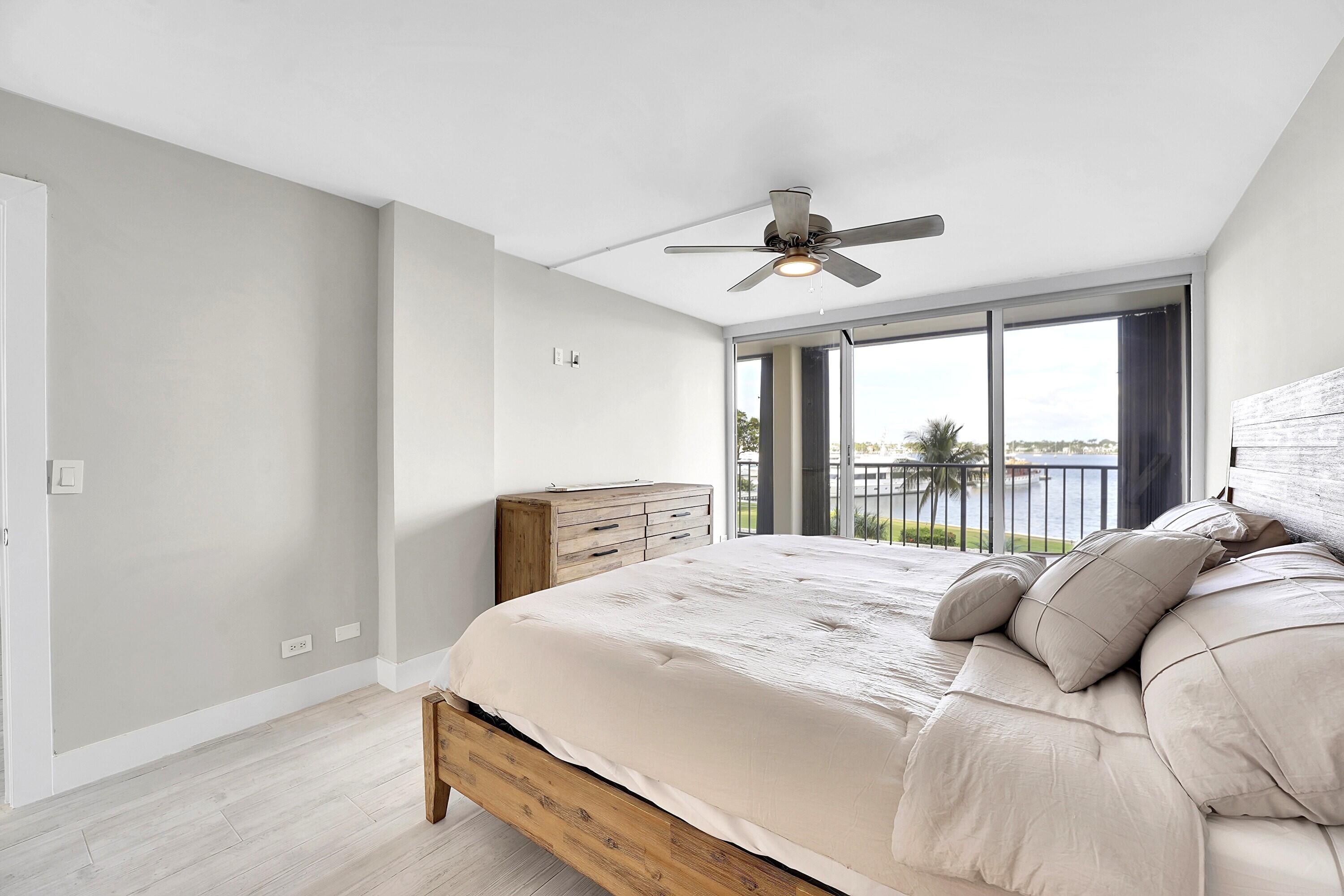 134 Lakeshore Drive, Unit 316 North Palm Beach, FL 33408 - Photo 10 of 30 a bedroom with a large bed and a large window
