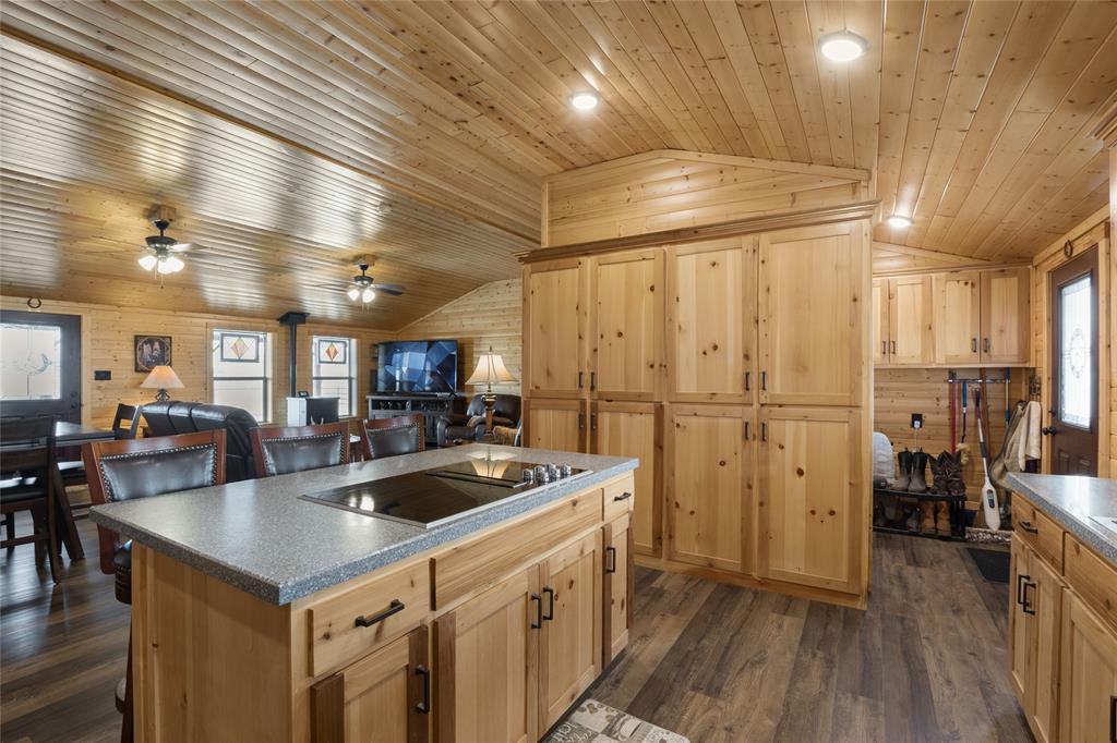 2290 Brooks Lane Sadler, TX 76264 - Photo 20 of 38 a kitchen that has a lot of cabinets a sink and wooden floor