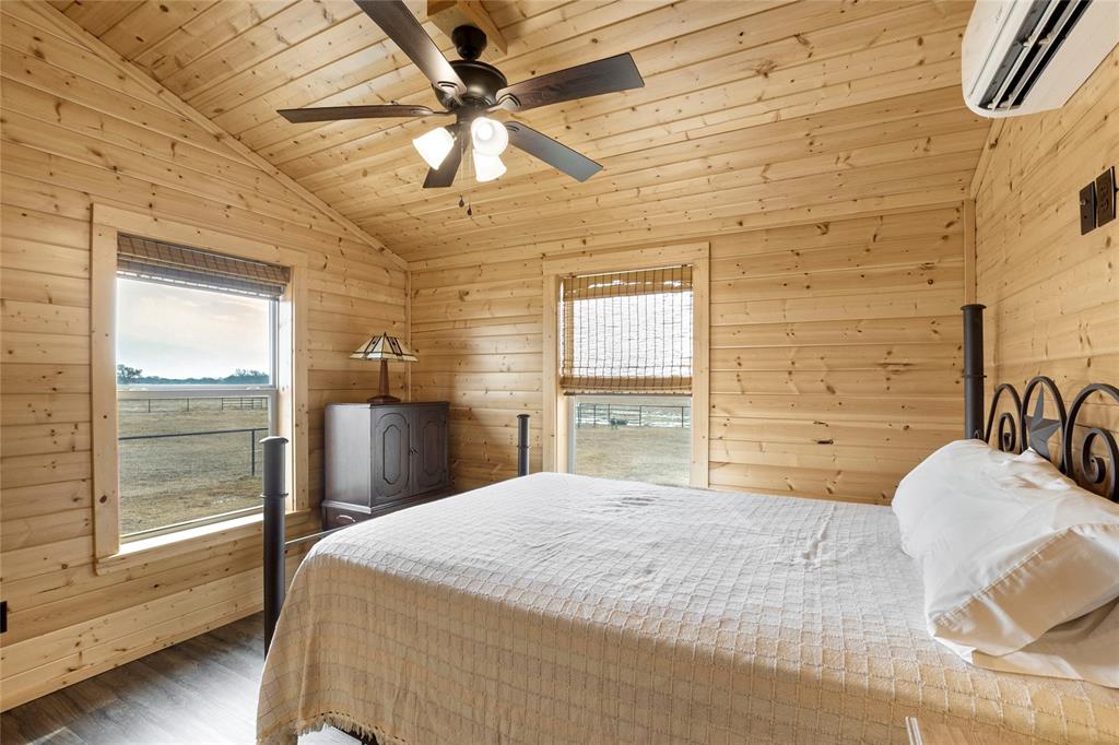2290 Brooks Lane Sadler, TX 76264 - Photo 29 of 38 a bedroom with a bed and a chandelier