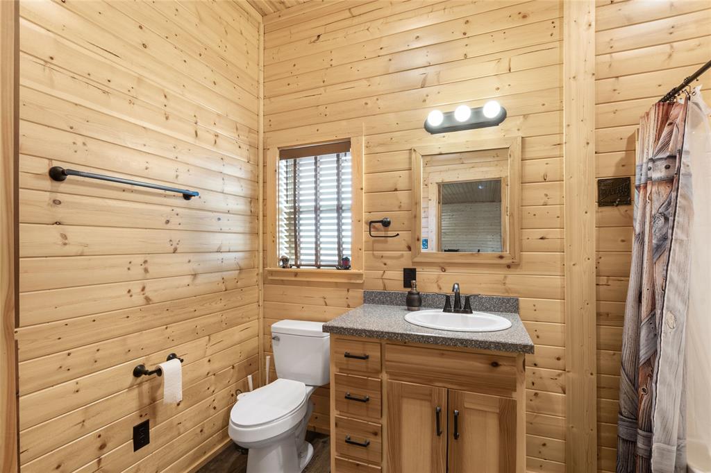 2290 Brooks Lane Sadler, TX 76264 - Photo 30 of 38 a bathroom with a sink a toilet and shower curtain