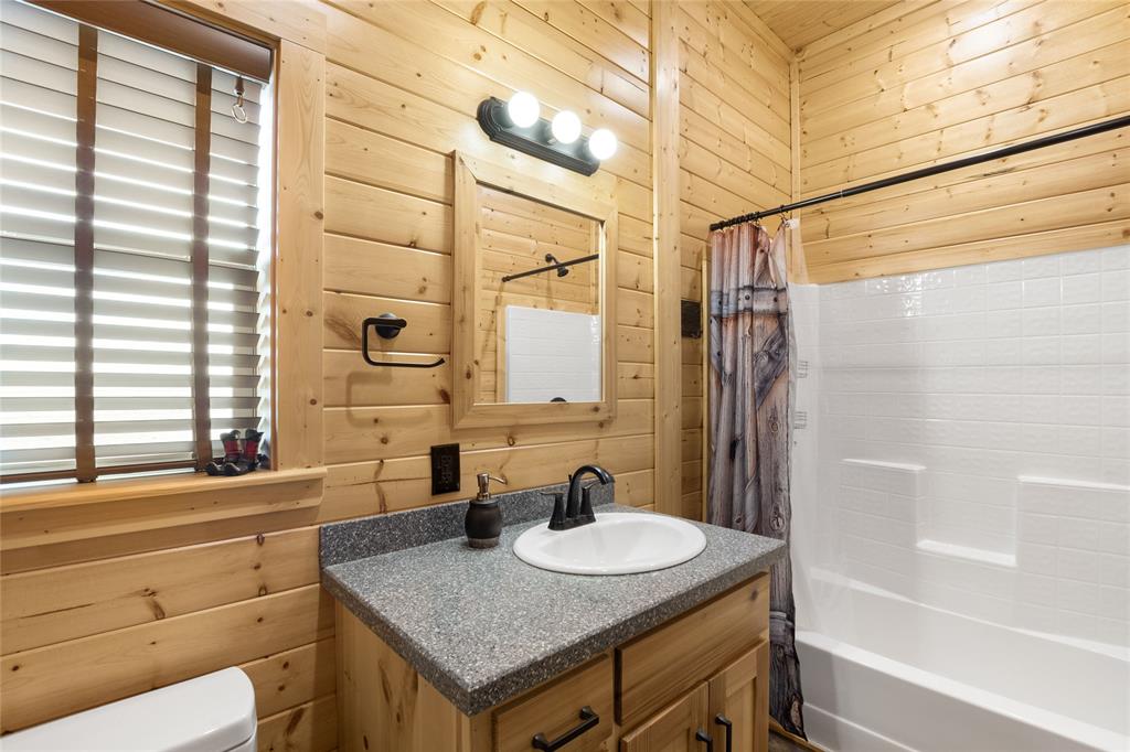 2290 Brooks Lane Sadler, TX 76264 - Photo 31 of 38 a bathroom with a granite countertop sink and a mirror