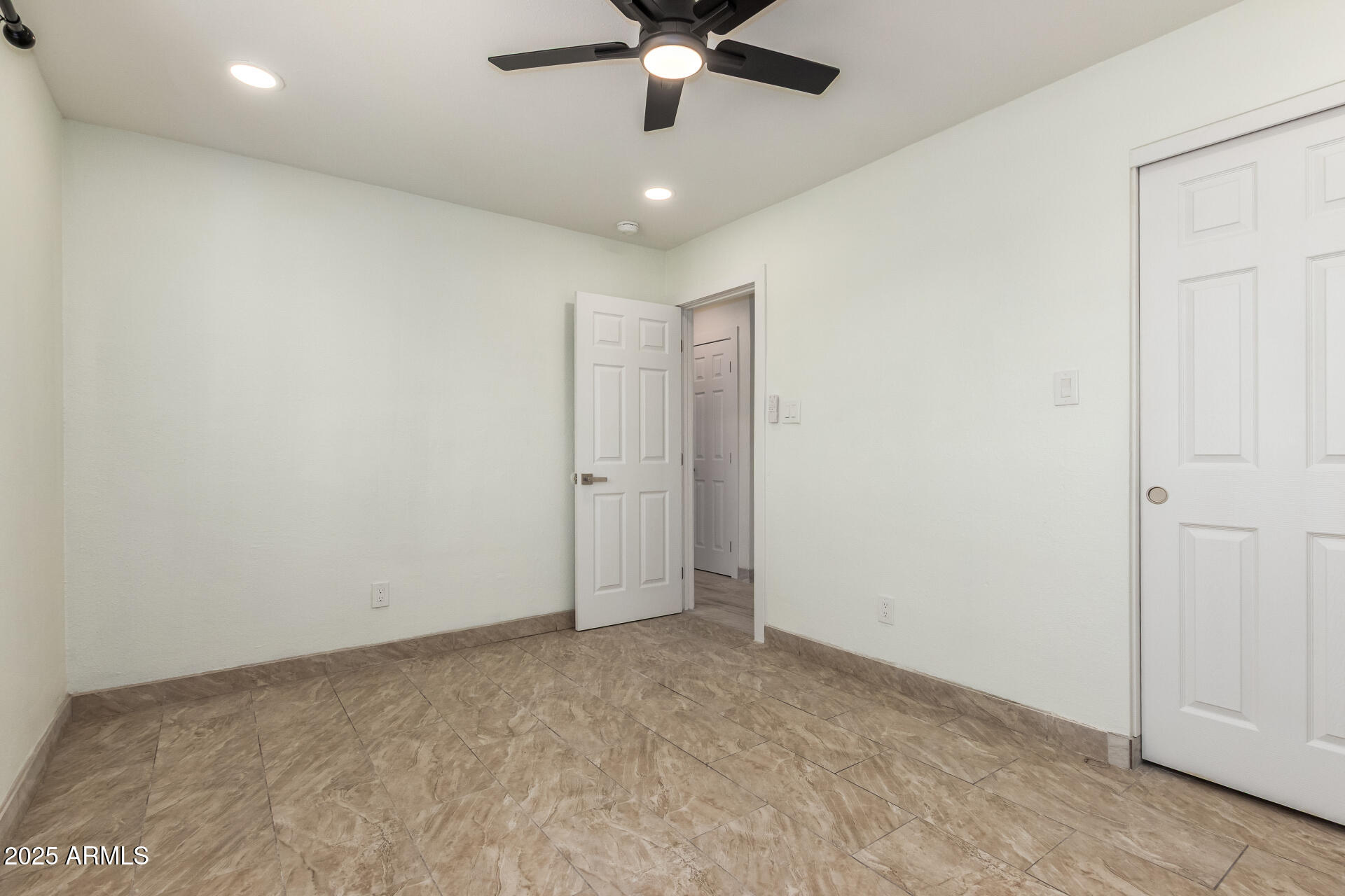 2239 West Bethany Home Road Phoenix, AZ 85015 - Photo 22 of 28 an empty room with ceiling fan and window