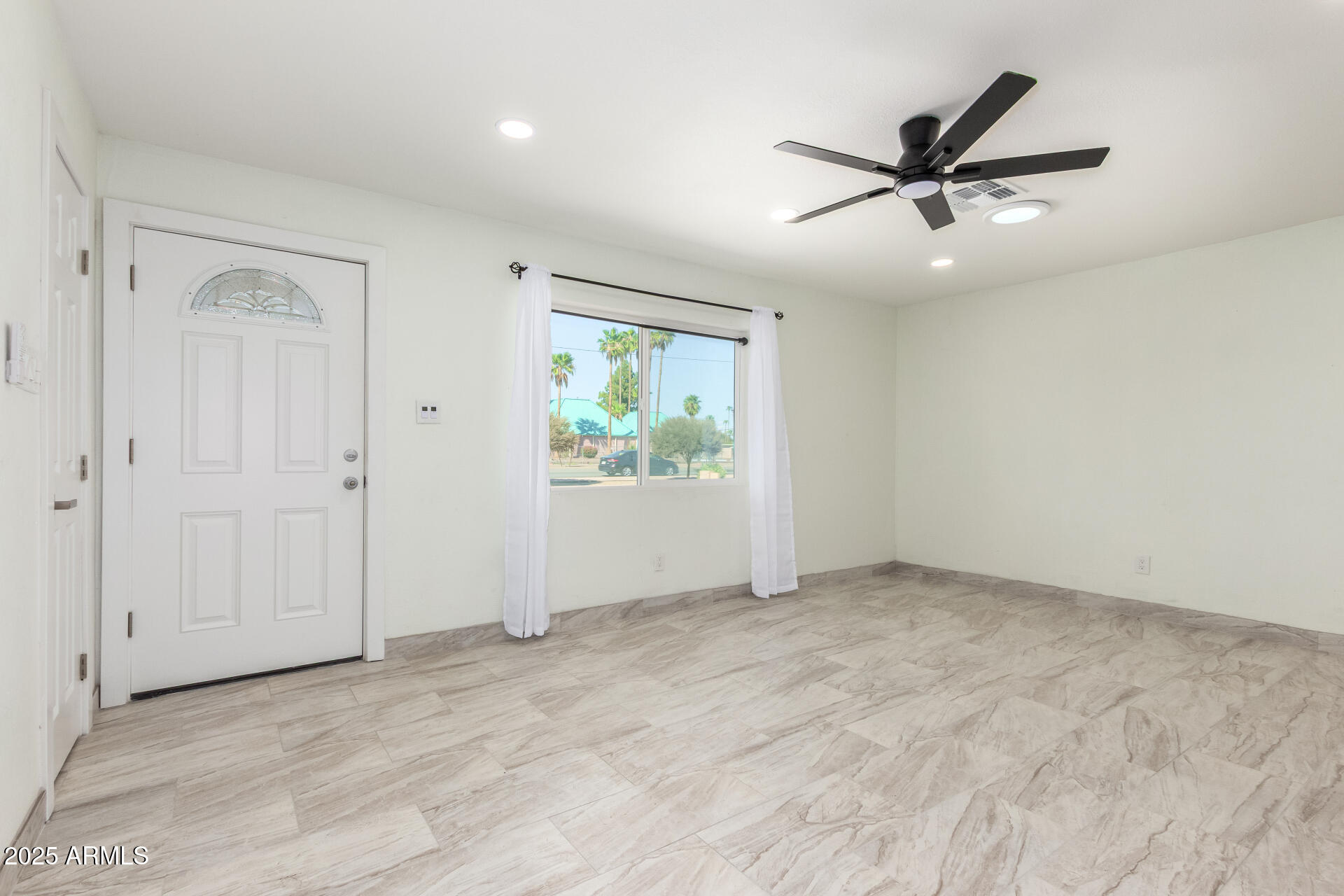 2239 West Bethany Home Road Phoenix, AZ 85015 - Photo 6 of 28 a view of an empty room with a window