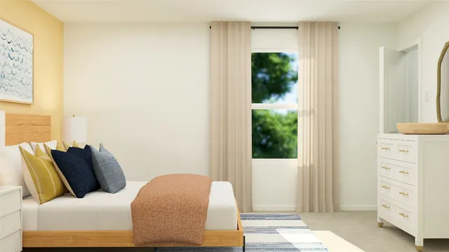 a bedroom with a bed and a dresser