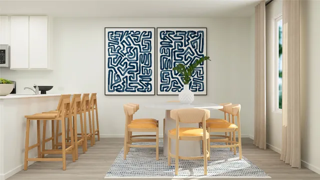 a living room with furniture a rug and a potted plant