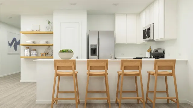 a kitchen with stainless steel appliances granite countertop a refrigerator and microwave