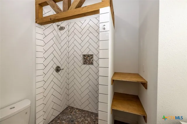 a bathroom with a shower and a sink