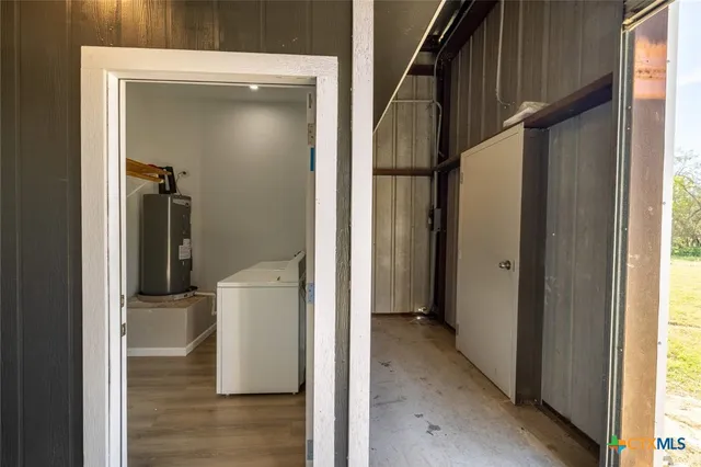 a view of hallway with wooden floor and stairs