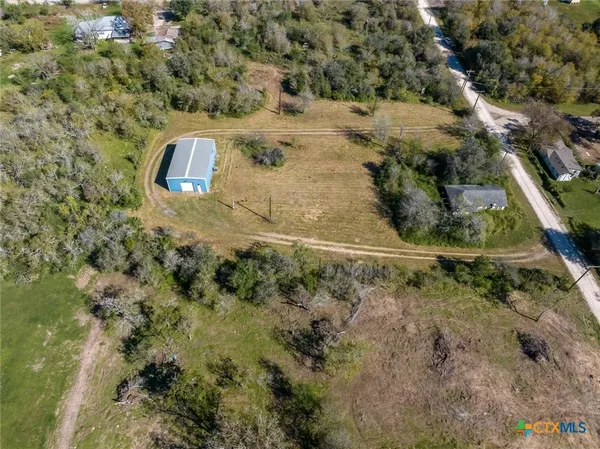 a aerial view of a house with a yard