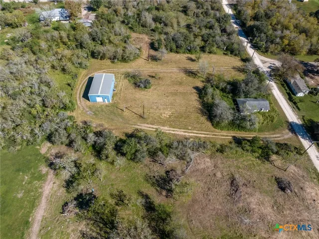 a aerial view of a house with a yard