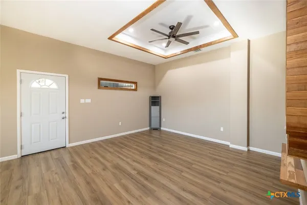 a view of empty room with wooden floor